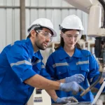 Engineers using laptop to implement poka yoke in lean manufacturing